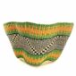 Front view of the green and orange bolga wave basket on a white background