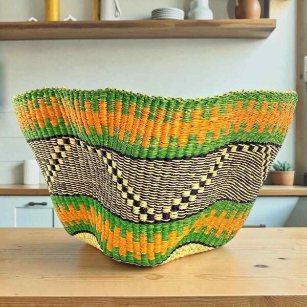 Bolga wave basket in green and orange, handwoven from elephant grass