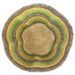 Top-down view inside the green and yellow bolga wave basket, showing the coiled base