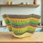 Bolga wave basket in green and yellow, handwoven from elephant grass