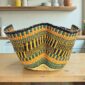 Bolga wave basket in orange and navy, handwoven from elephant grass