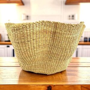 a woven basket in a rippling wave effect, natural colour of elephant grass.