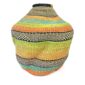 Front view of the orange, teal and lime green Bolga wave pot basket showing the woven neck