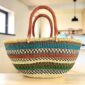 Mega Wawa basket with teal, rust, navy and green banded stripes, leather handles