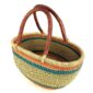 Angled view of the orange and teal Mega Wawa Bolga basket showing the woven interior and leather handles