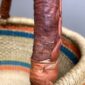 Close-up of the scuffing on the leather handle of the orange and teal Mega Wawa basket
