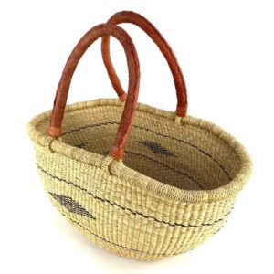 Angled view of the natural Mega Wawa Bolga basket showing the woven interior and leather handles