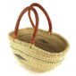 Angled view of the natural Mega Wawa Bolga basket showing the woven interior and leather handles