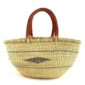 Front view of the natural Mega Wawa Bolga basket with two leather handles on a white background