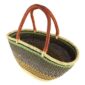 Angled view of the olive green and rust Mega Wawa Bolga basket showing the woven interior and leather handles