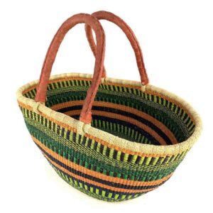 Angled view of the green and orange striped Mega Wawa Bolga basket showing the woven interior and leather handles