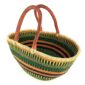 Angled view of the green and orange striped Mega Wawa Bolga basket showing the woven interior and leather handles