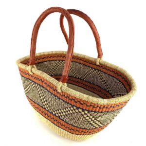 Angled view of the orange zigzag Mega Wawa Bolga basket showing the woven interior and leather handles
