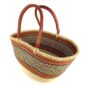 Angled view of the orange zigzag Mega Wawa Bolga basket showing the woven interior and leather handles