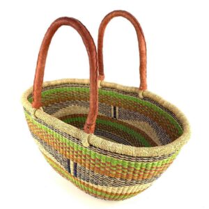 Angled view of the lime and orange Mega Wawa Bolga basket showing the woven interior and leather handles