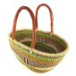 Angled view of the lime and orange Mega Wawa Bolga basket showing the woven interior and leather handles