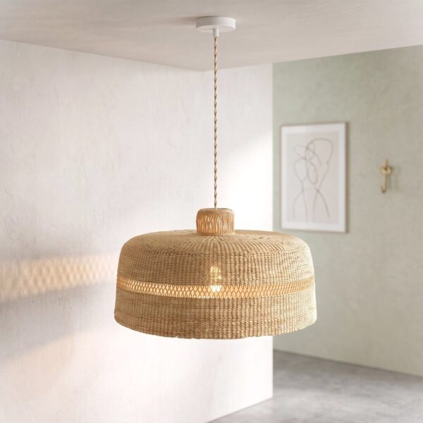 Woven bolga lampshade hanging near a window, fully undyed natural straw