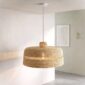 Woven bolga lampshade hanging near a window, fully undyed natural straw
