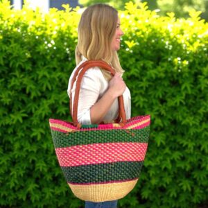 Model holding a Ghanaian market basket on her shoulder for scale