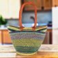 Long handle market basket with patterned bands in soft, cool tones and leather-wrapped handles