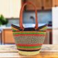 Long handle market basket with a dark chequered pattern with bright accent stripes and leather-wrapped handles
