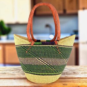Long handle market basket with an open weave and a diagonal pattern in cool, earthy tones and leather-wrapped handles