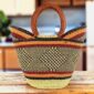 Classic market basket with warm, earthy stripes around a dark diamond pattern and leather-wrapped handles